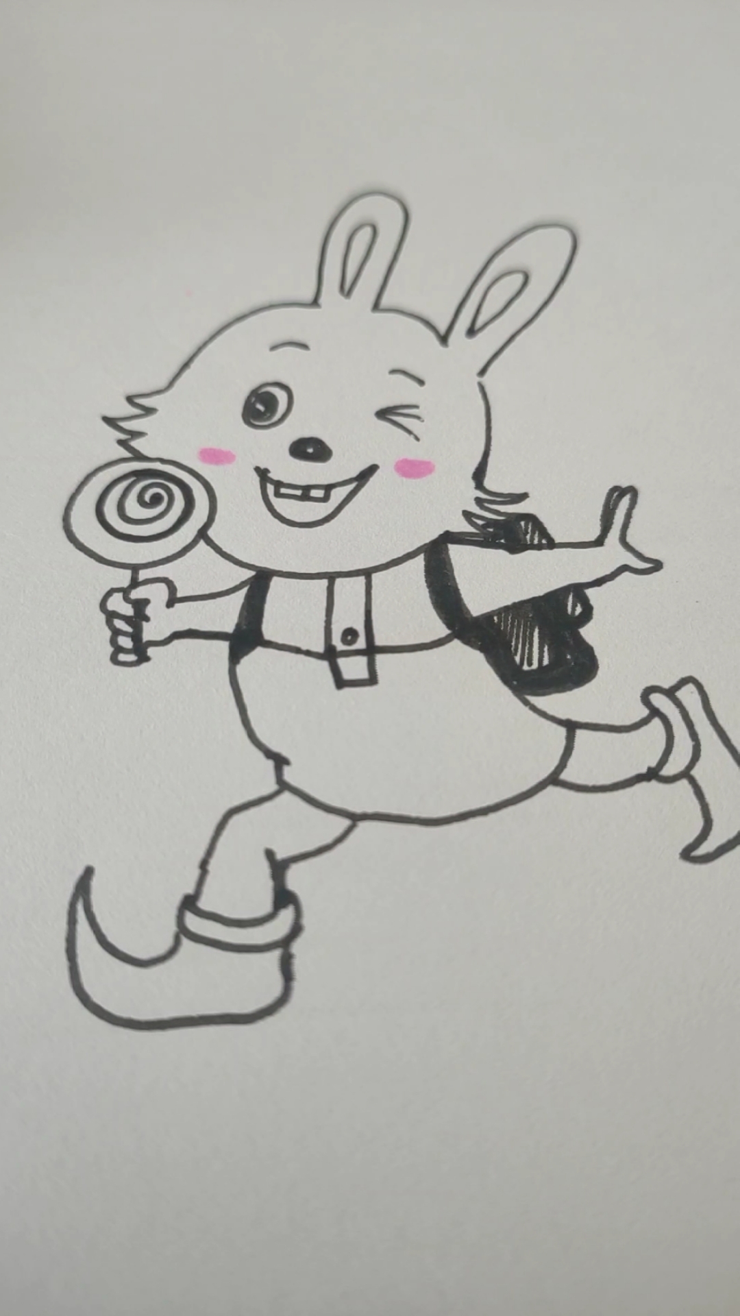 画一画吃棒棒糖的小兔子.